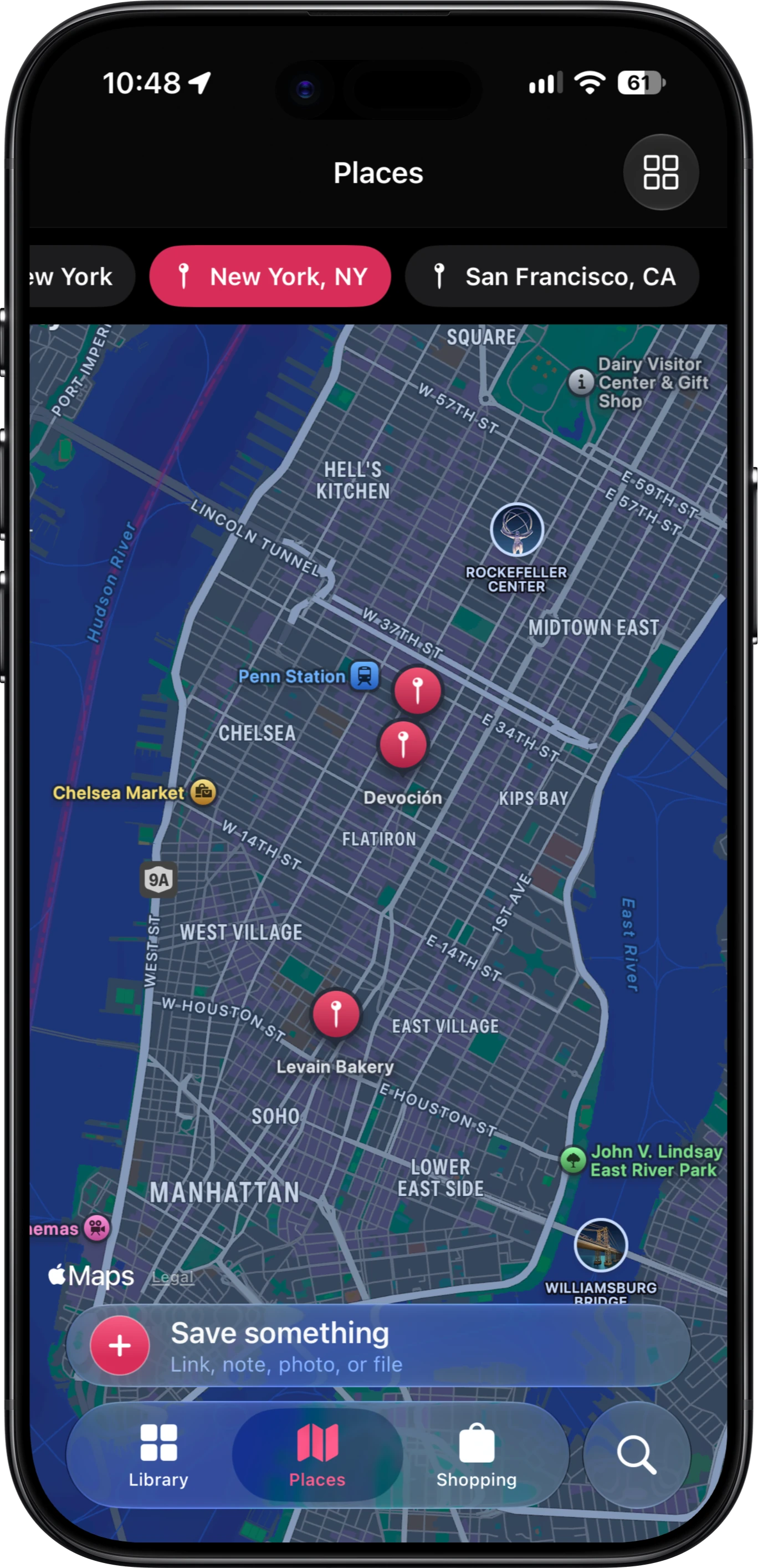 The FaveNest Places tab on an iPhone in dark mode: city filters for New York, NY and San Francisco, CA above an Apple Maps view of Manhattan with saved pins for Devoción, Levain Bakery and a spot near Penn Station, and the tab bar floating over the map.